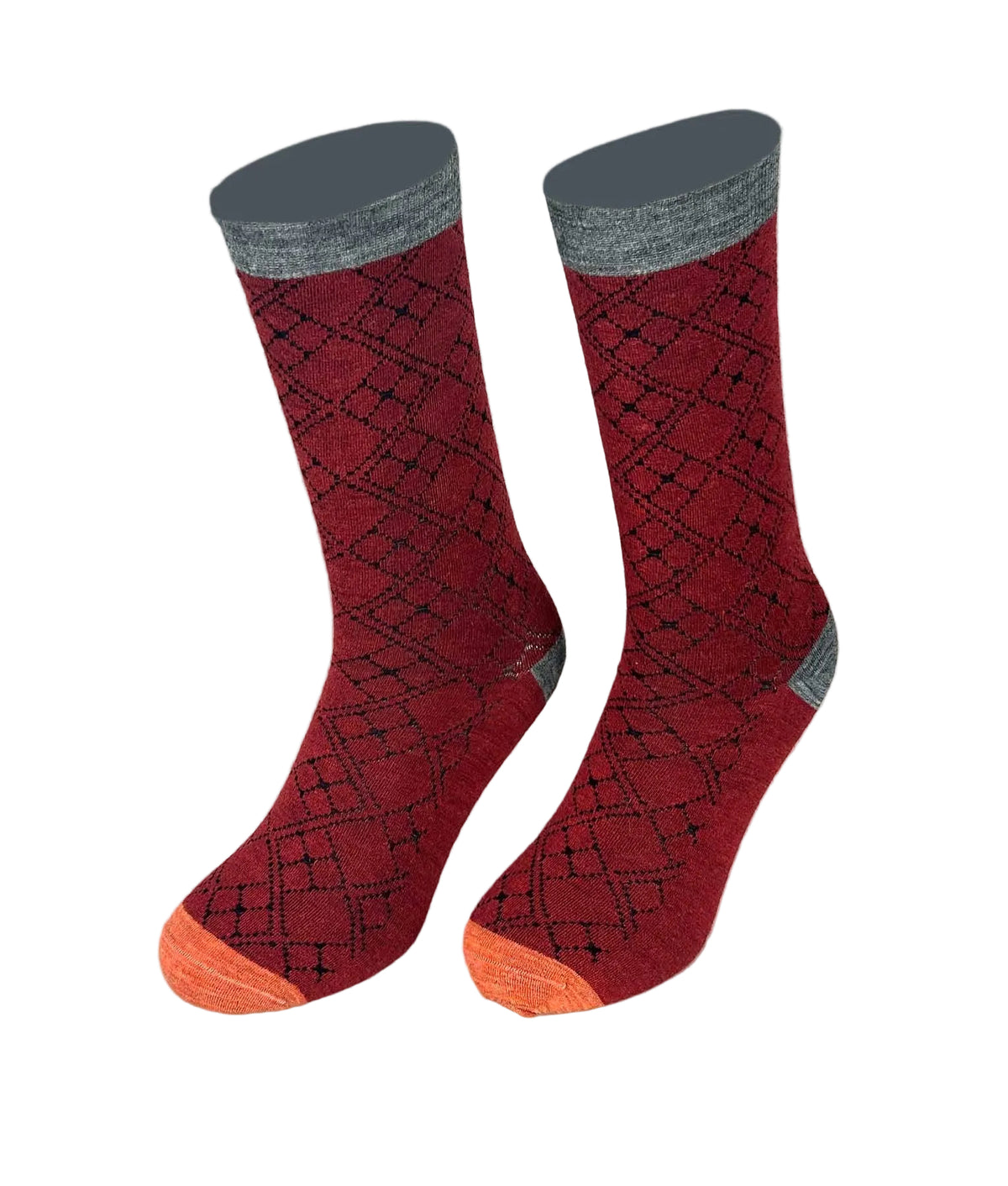 Pair of red socks with gray cuffs and orange toes on a beige background