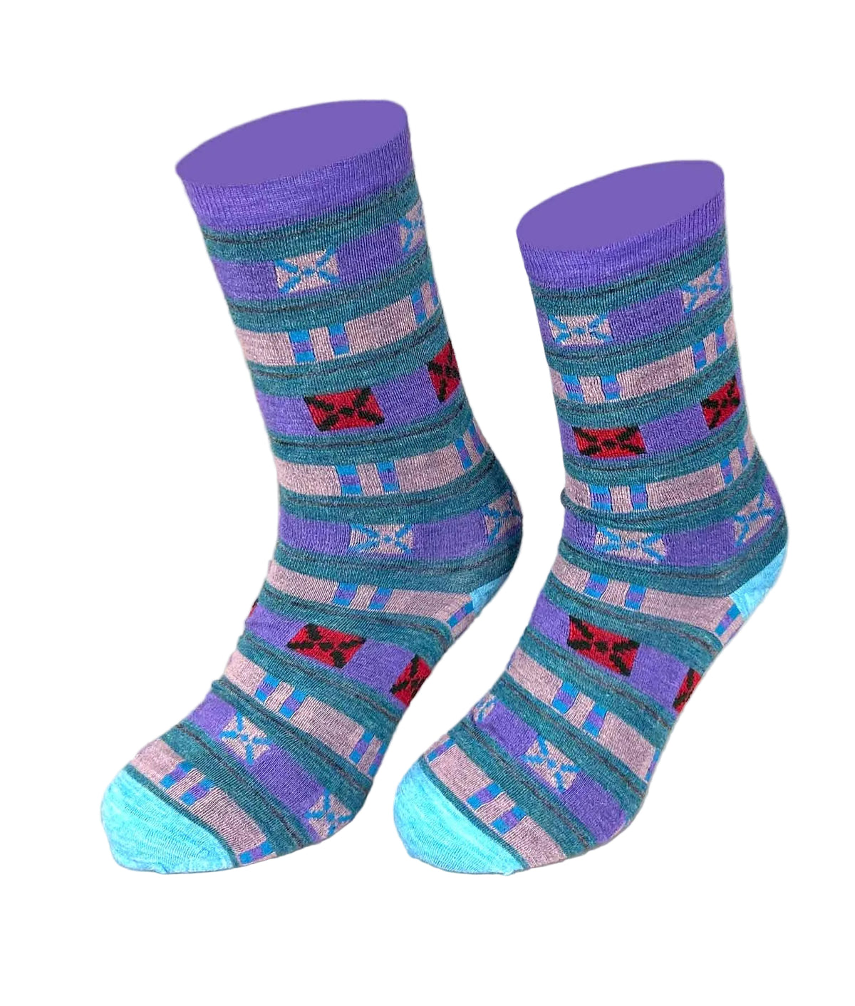 A pair of crew socks with a Southwestern geometric pattern in purple, teal, pink, and light blue, displayed on a neutral beige background.